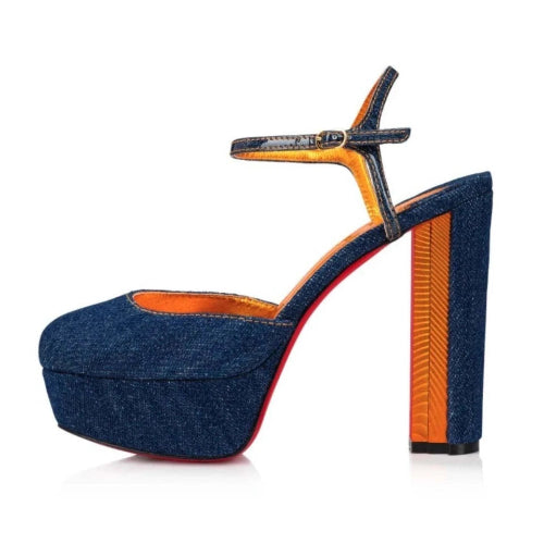 Blue denim high-heeled shoe with orange interior on a white background