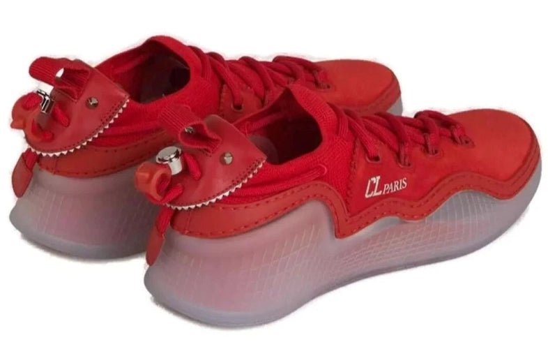 A pair of red low-top athletic sneakers with chunky translucent red and white midsoles, shown against a plain white background.