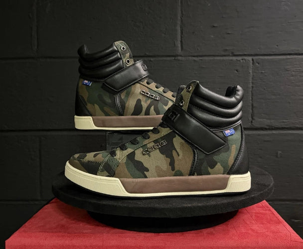 Camouflage-patterned high-top sneakers on a red platform with a black sole.