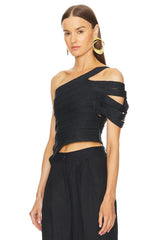 Woman wearing a black one-shoulder top with cut-out design on a white background