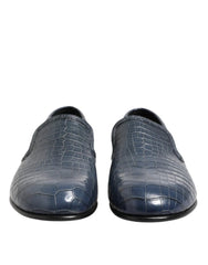 Pair of blue textured loafers on a white background