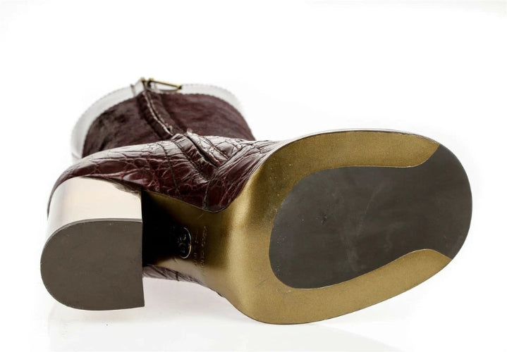 A close-up of a brown leather boot or shoe showing the heel and outsole against a white background.