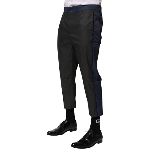 Black pants worn by a person on a white background