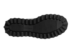 A close-up view of a black lug sole with the brand name 'DOLCE&GABBANA' embossed on the center, set against a plain white background.