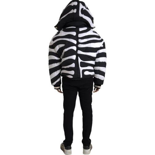 Person wearing a black and white zebra-striped hoodie on a white background