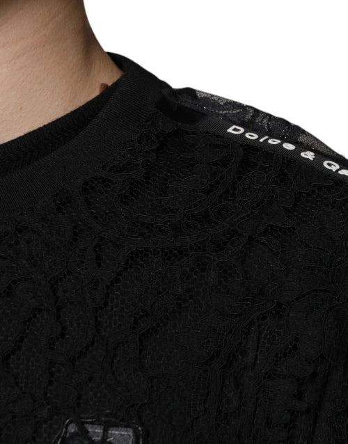 Close-up of a black cable knit sweater with a brand logo on a white background