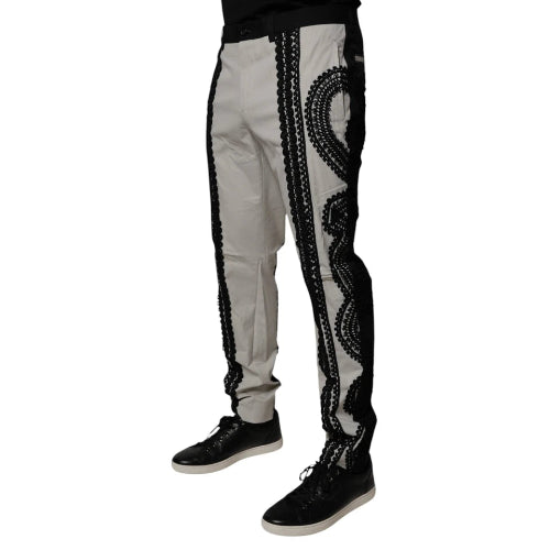 Light gray pants with black decorative patterns on a white background