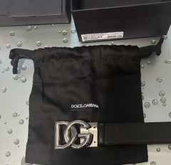 Dolce & Gabbana belt with drawstring bag on a metallic surface
