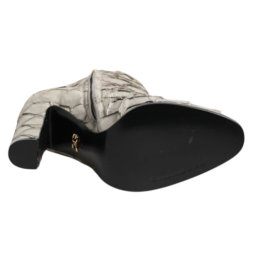 Quilted gray shoe with black sole on a white background