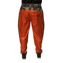 Red pants worn by a person on a white background
