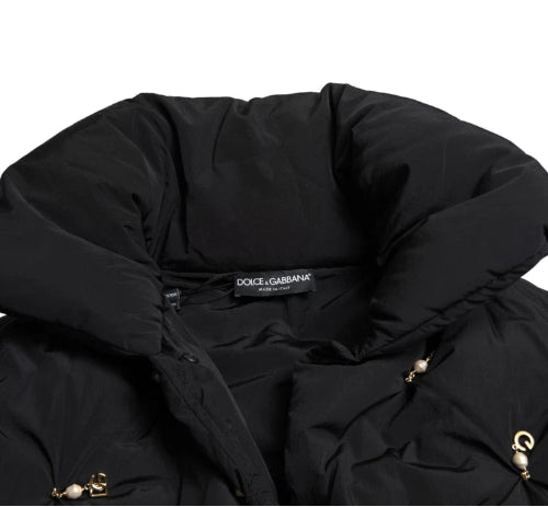 Black puffer jacket with Dolce & Gabbana label on a white background