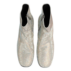 A pair of silver snakeskin ankle boots covered in sparkling rhinestones, shown from a top-down view on a white background.