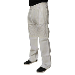 A pair of off-white or cream-colored canvas utility pants worn by a model, paired with black shoes, shown from the waist down on a white background.