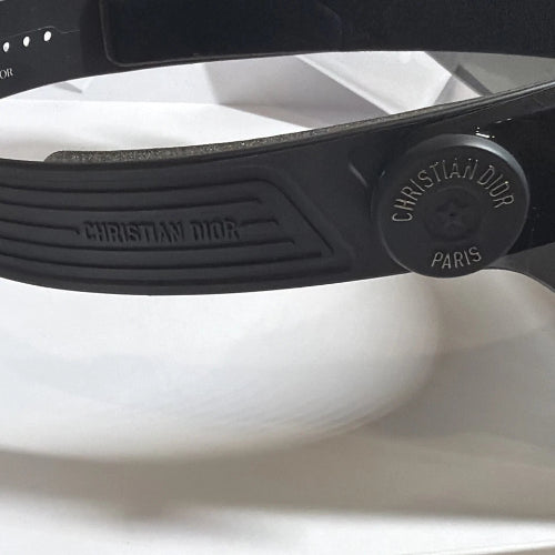Close-up of a black Christian Dior sunglasses on a white background