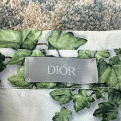 Dior fabric with green leaf pattern and visible label on a textured surface