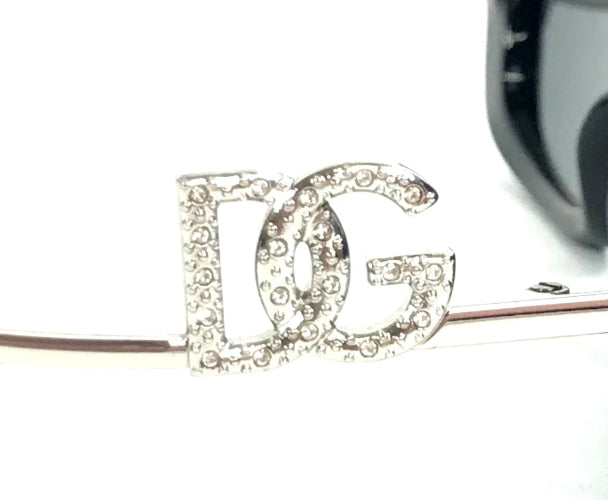Silver hair clip with 'DG' letters on a white background
