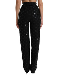 Black pants with a subtle pattern worn by a person on a white background