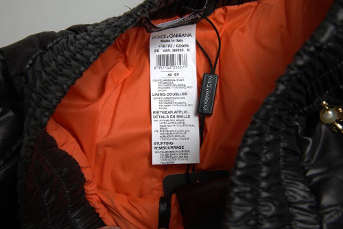 Close-up of a Dolce & Gabbana label on an orange and black garment.