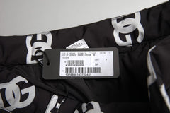 Black pants with white logo pattern and a tag on a light gray background