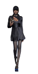 Person wearing a black outfit with a hood and pleated skirt on a white background