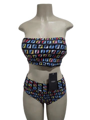 Bikini set with colorful pattern on a mannequin against a white door background
