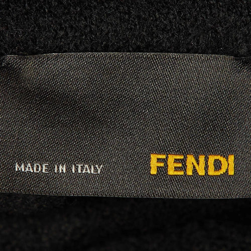 Fendi label on a textured black background