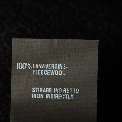 Text label on fabric with care instructions and material information.