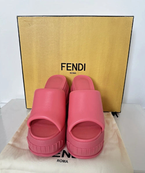 Pink slides with a Fendi box in the background