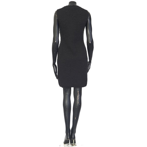 Black dress on a mannequin against a white background