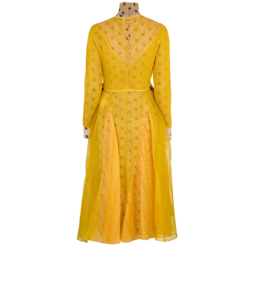 Yellow dress on a mannequin against a white background