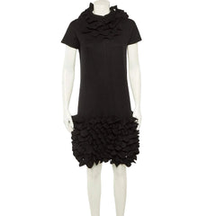 Black dress with ruffled skirt on a white background