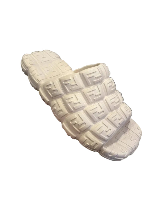 Close-up of a person wearing a white sneaker with a textured sole.