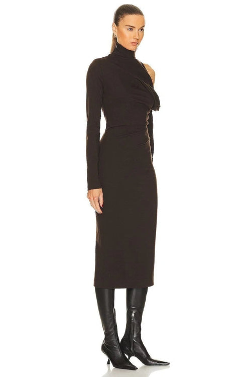 Woman wearing a black dress with cut-out shoulders on a white background