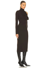 Woman wearing a black dress with cut-out shoulders on a white background