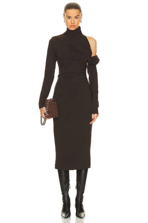 Woman wearing a black dress with cut-out shoulders on a white background