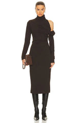 Woman wearing a black dress with cut-out shoulders on a white background