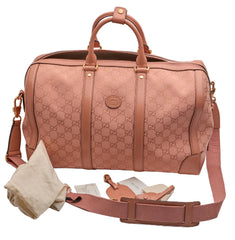 Pink patterned bag with matching strap and dust cover on a light gray background