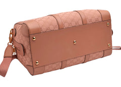 Pink handbag with gold accents on a white background