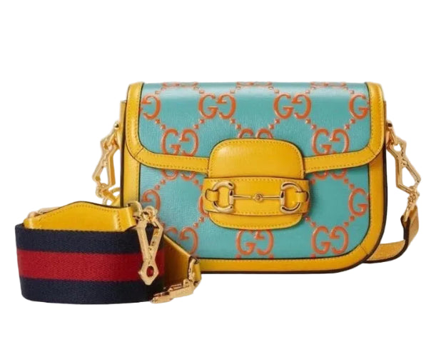 Colorful handbag with decorative patterns on a plain background