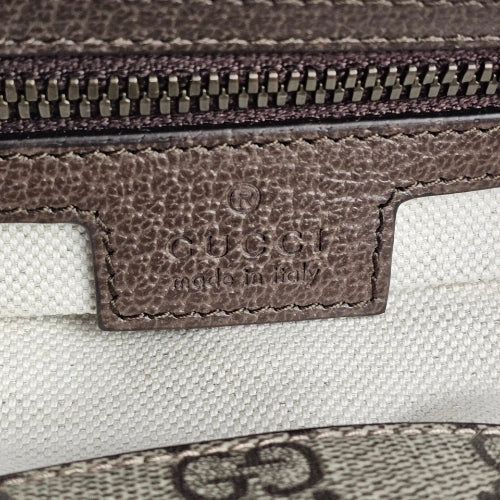 Close-up of Gucci logo on a textured surface