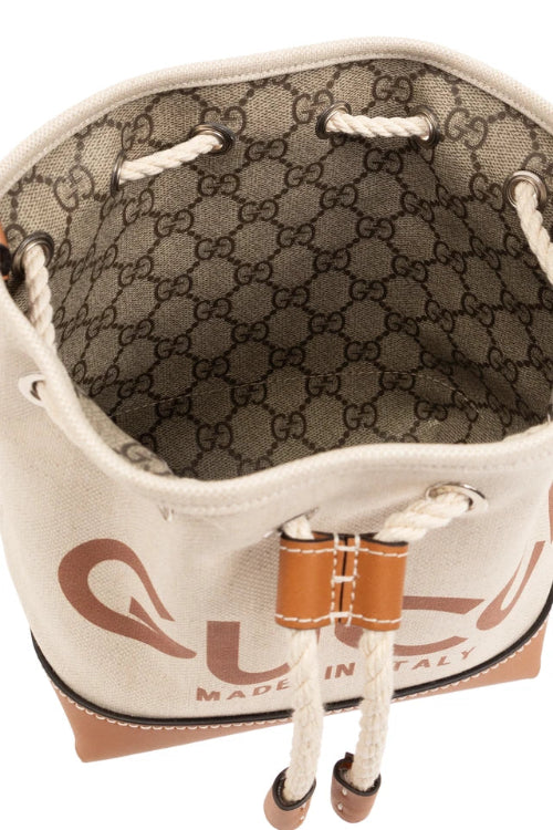 Close-up of a Gucci bag with visible logo and 'Made in Italy' text.