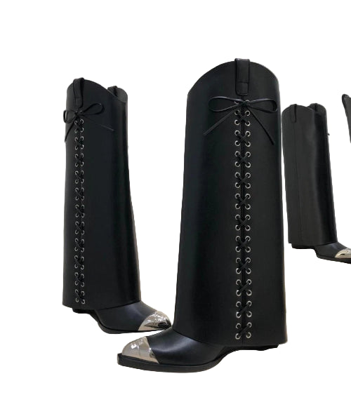 Black knee-high boots with silver accents on a white surface