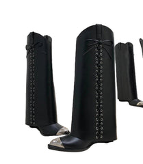 Black knee-high boots with silver accents on a white surface