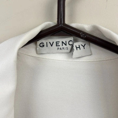 White garment on a Givenchy hanger with visible brand name.