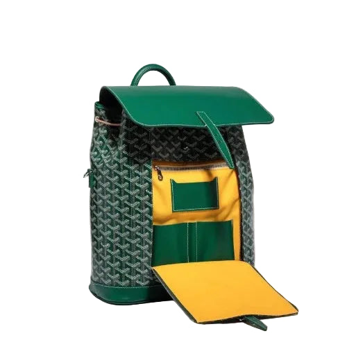 A Goyard backpack in green and black monogram canvas with a bright green leather flap and a yellow interior pocket, shown open on a light beige background.