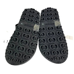 Black rubber sole of a shoe with brand logo on a white background