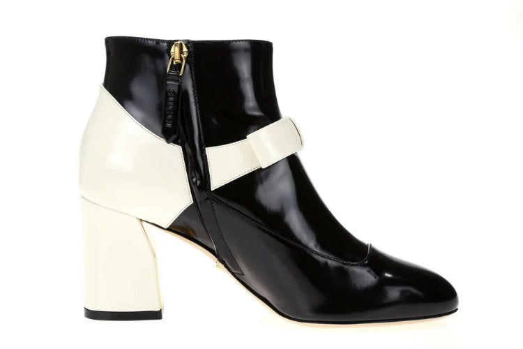 Black and white ankle boot with block heel on a white background