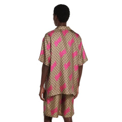 Person wearing a patterned dress with a plain background