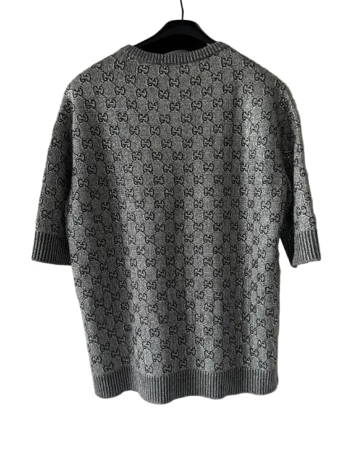 Gray patterned shirt on a hanger against a white background
