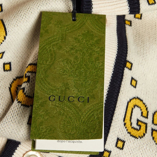 Green Gucci tag on a patterned background